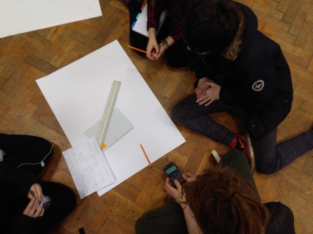 Students measuring the school hall to make scaled plan drawings